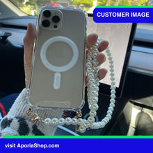 Load image into Gallery viewer, Image of a customer holding the Aporia Magsafe Clear Case - Pearl Crossbody Strap for iPhone 15/14/13/12 inside Tesla Car
